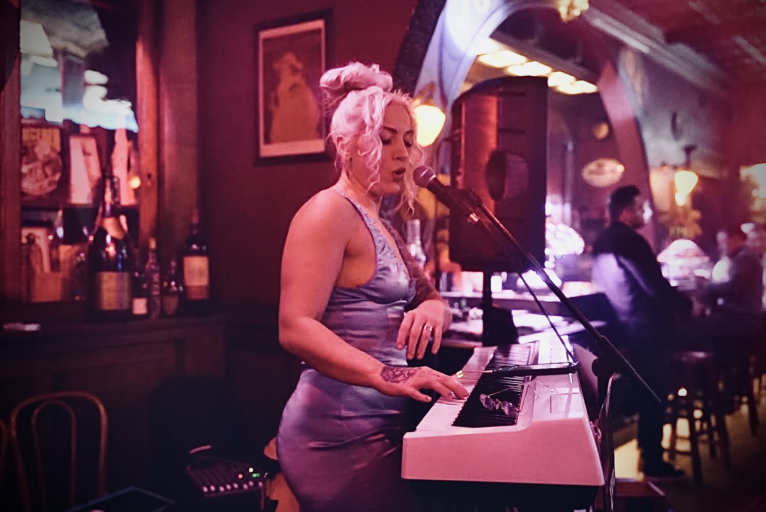 Clarissa at the piano in an intimate lounge